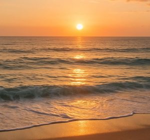 Early morning sunrise over ocean from beach