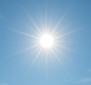 Midday sun in clear blue sky