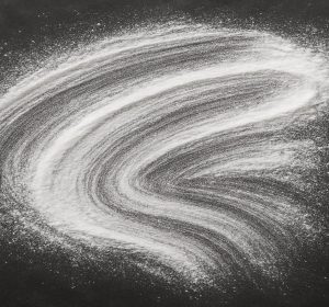 Raw azelaic acid powder brushed on dark plate